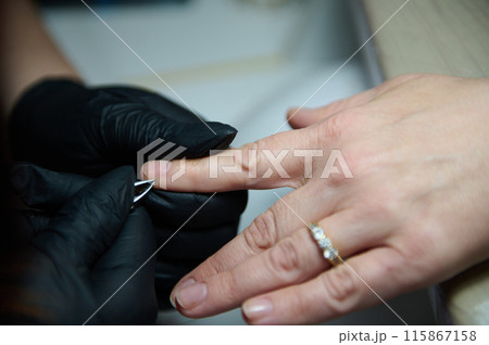 Manicure session in a beauty salon with gloved hands Manicure session in a beauty salon with gloved hands 115867158