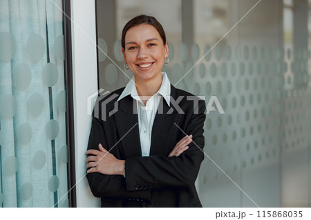 Confident businesswoman in stylish office, conveying professionalism and success with a smile Confident businesswoman in stylish office, conveying professionalism and success with a smile 115868035