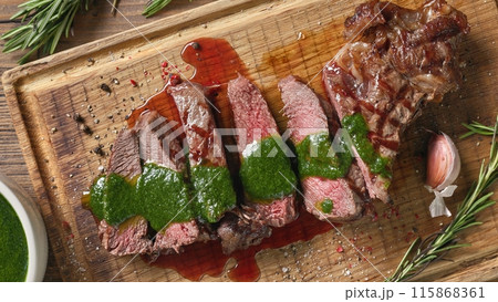 freshly grilled sliced steak with green parsley sauce freshly grilled sliced steak with green parsley sauce 115868361