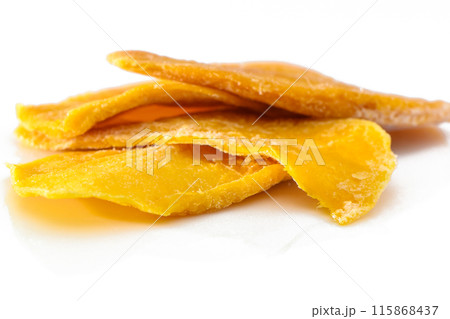Dried mango slices close-up on a white. Top view 1 Dried mango slices close-up on a white. Top view 1 115868437