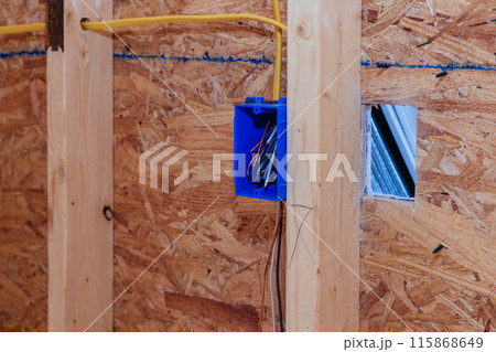 Installing mounting wiring in wall electric box for socket in new house 115868649