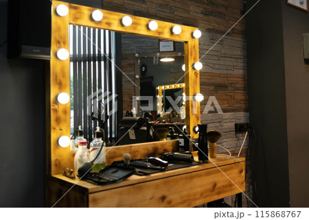 Wooden vanity mirror with lights in a barber shop 115868767