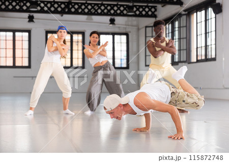 Young man breakdancer doing handstand 115872748