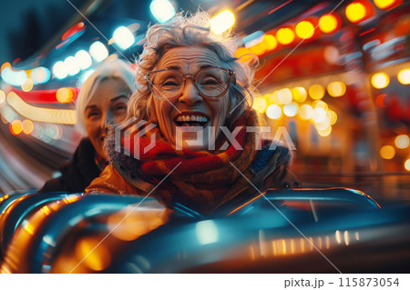 Two elderly friends share unstoppable laughter as they speed down a roller coaster against a backdrop of dazzling lights 115873054