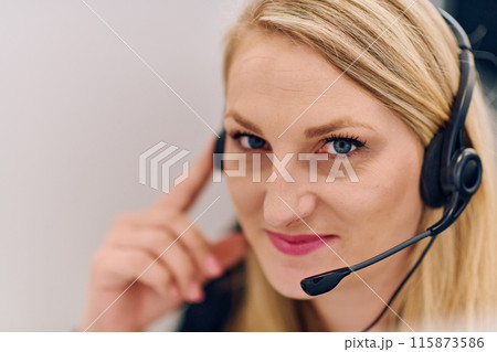 Friendly Call Center Agent Answering Incoming Calls with Headset Providing Remote Customer Service. Friendly Call Center Agent Answering Incoming Calls with Headset Providing Remote Customer Service. 115873586