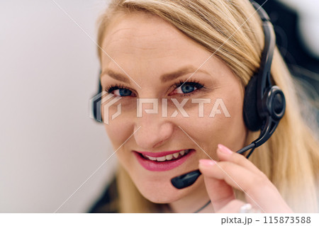 Friendly Call Center Agent Answering Incoming Calls with Headset Providing Remote Customer Service. Friendly Call Center Agent Answering Incoming Calls with Headset Providing Remote Customer Service. 115873588