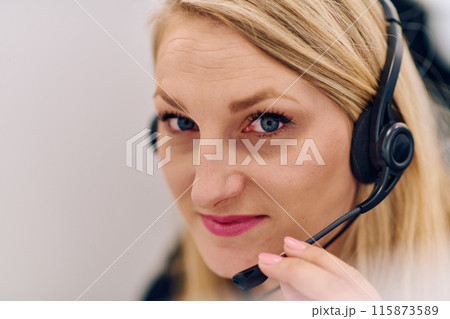 Friendly Call Center Agent Answering Incoming Calls with Headset Providing Remote Customer Service. 115873589