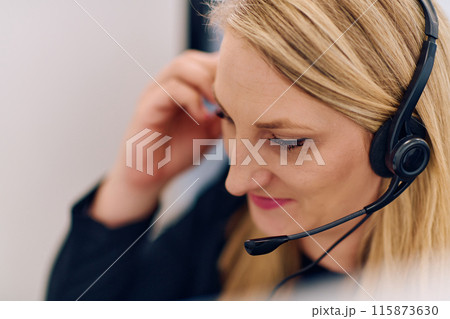 Friendly Call Center Agent Answering Incoming Calls with Headset Providing Remote Customer Service. 115873630