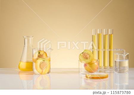 Template for design with fresh peach experiment concept, from front angle on yellow background. In the middle of table is an presentation space for natural cosmetic product, glassware placed beside 115873780