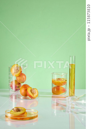 Laboratory layout with fresh peach for advertising pic of cosmetic products, which has peach scent or composition. Frontal shot photo with empty space for designing Laboratory layout with fresh peach for advertising pic of cosmetic products, which has peach scent or composition. Frontal shot photo with empty space for designing 115873810