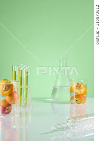 Template photo for nature cosmetic product advertisement, which has peach as the one of ingredient. Displaying space in center, lab glassware and fresh peach decorated on both sides Template photo for nature cosmetic product advertisement, which has peach as the one of ingredient. Displaying space in center, lab glassware and fresh peach decorated on both sides 115873812