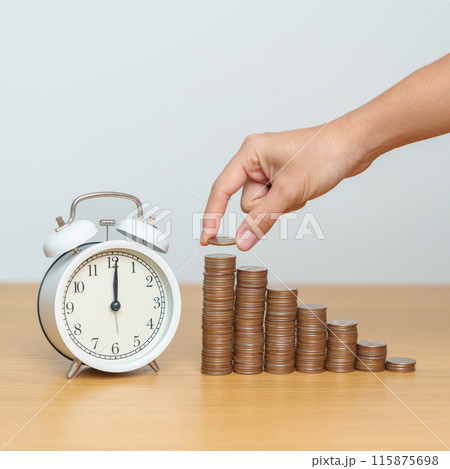 Money Saving for Future Plan, Retirement fund, Pension, Investment, Wealth Business and Financial concepts. hand putting coin on money stack with clock on table 115875698