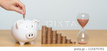 Money Saving for Future Plan, Retirement fund, Pension, Investment, Wealth Business and Financial concepts. hand putting coin into piggy bank with sandglass, Counting and stack arrangement for deposit 115875701