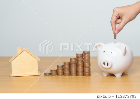 Money Saving, Property investment, House Mortgage and Real Estate Financial concepts. hand putting coin into piggy bank with Home model, Money stack Counting arrangement for deposit and Tax 115875705