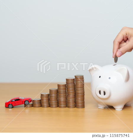 Money Saving, Car Insurance, Financial, vehicle Repair and Maintenance concepts. hand putting coin into piggy bank with Auto model, Money stack Counting arrangement for deposit and Automobile Tax 115875741
