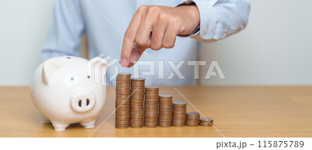 Money Saving for Future Plan, Retirement fund, Pension, Investment, Wealth Business and Financial concepts. hand putting coin into piggy bank on table, Money Counting and stack arrangement for deposit Money Saving for Future Plan, Retirement fund, Pension, Investment, Wealth Business and Financial concepts. hand putting coin into piggy bank on table, Money Counting and stack arrangement for deposit 115875789