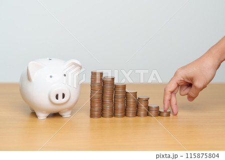 Money Saving for Future Plan, Retirement fund, Pension, Investment, Wealth, Salary and Financial concepts. hand step up coin with piggy bank on table, Money Counting and stack arrangement for Growth 115875804