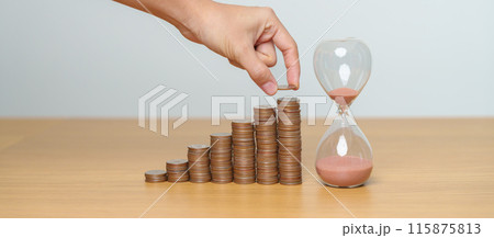 Money Saving for Future Plan, Retirement fund, Pension, Investment, Wealth Business and Financial concepts. hand putting coin on money stack with sandglass 115875813