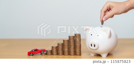 Money Saving, Car Insurance, Financial, vehicle Repair and Maintenance concepts. hand putting coin into piggy bank with Auto model, Money stack Counting arrangement for deposit and Automobile Tax Money Saving, Car Insurance, Financial, vehicle Repair and Maintenance concepts. hand putting coin into piggy bank with Auto model, Money stack Counting arrangement for deposit and Automobile Tax 115875823