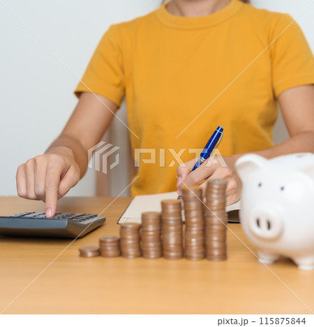 Money Saving for Future Plan, Retirement fund, Pension, Investment, Wealth Business and Financial concepts. Woman Counting and calculate money with coins stack with piggy bank for deposit Money Saving for Future Plan, Retirement fund, Pension, Investment, Wealth Business and Financial concepts. Woman Counting and calculate money with coins stack with piggy bank for deposit 115875844