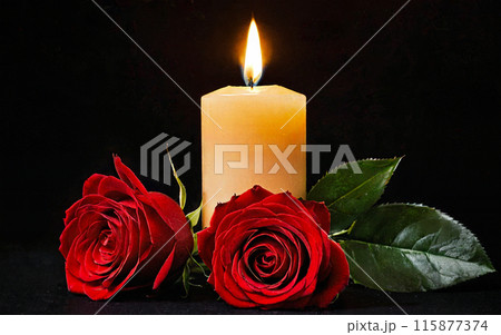 burning yellow candle and two red roses on a black background 115877374
