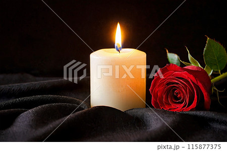 burning candle and red rose on a black background 115877375