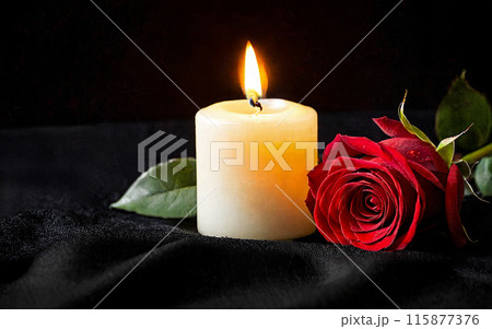 burning wax candle and red rose on a black background 115877376