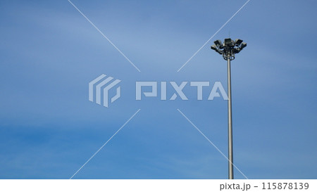 Spotlight pole on the side of the road The background is a blue sky 115878139