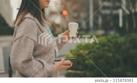 休憩時間にコーヒーをテイクアウトする20代OL 休憩時間にコーヒーをテイクアウトする20代OL 115878301