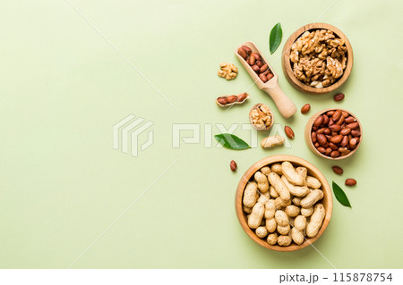 Walnut kernel halves, in a wooden bowl. Close-up, from above on colored background. Healthy eating Walnut concept. Super foods with copy space Walnut kernel halves, in a wooden bowl. Close-up, from above on colored background. Healthy eating Walnut concept. Super foods with copy space 115878754