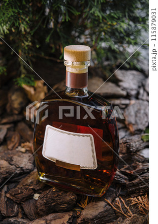 Artisanal brandy bottle in rustic setting 115879031