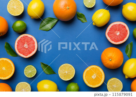 Flat lay of citrus fruits like lime, orange and lemon with lemon tree leaves on light colored background making a frame. Space for text healthy concept Flat lay of citrus fruits like lime, orange and lemon with lemon tree leaves on light colored background making a frame. Space for text healthy concept 115879091