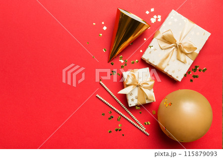 Holiday background with colorful balloon, gift and confetti. Flat lay style. Birthday or party greeting card with copy space Holiday background with colorful balloon, gift and confetti. Flat lay style. Birthday or party greeting card with copy space 115879093