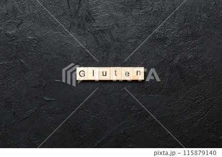 gluten word written on wood block. gluten text on table, concept gluten word written on wood block. gluten text on table, concept 115879140