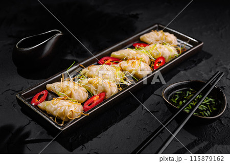 Exquisite asian dumplings with dipping sauce Exquisite asian dumplings with dipping sauce 115879162