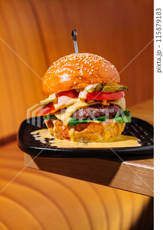 Gourmet cheeseburger on warm background 115879183