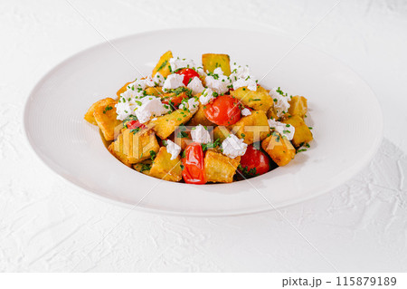 Fresh homemade polenta with tomatoes and feta Fresh homemade polenta with tomatoes and feta 115879189