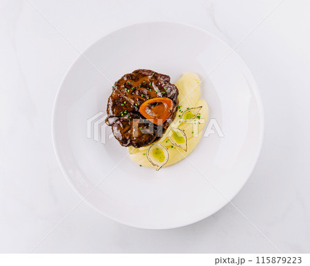 Gourmet steak with mashed potatoes on white plate 115879223