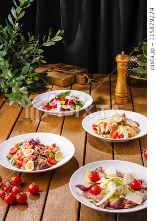Gourmet salad selection on wooden table 115879224