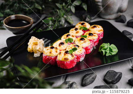 Delectable torched sushi platter on black slate 115879225