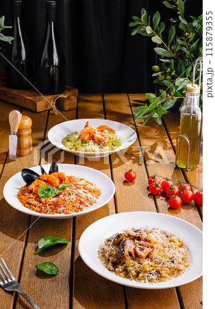 Gourmet italian pasta dishes on rustic wooden table Gourmet italian pasta dishes on rustic wooden table 115879355