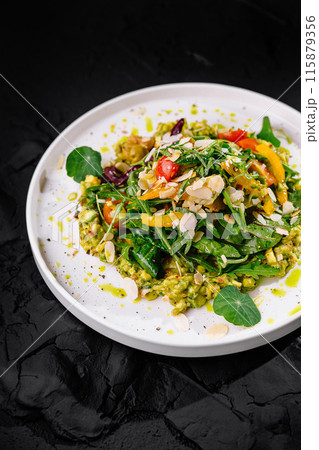 Gourmet vegetarian salad on dark background Gourmet vegetarian salad on dark background 115879356