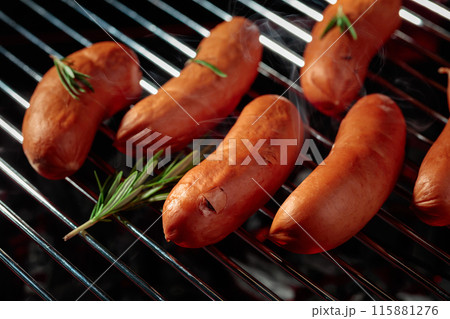 Grilled sausages with rosemary on a grill. Grilled sausages with rosemary on a grill. 115881276