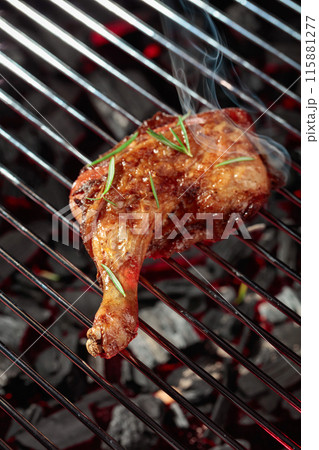 Chicken with rosemary on a grill. Chicken with rosemary on a grill. 115881277