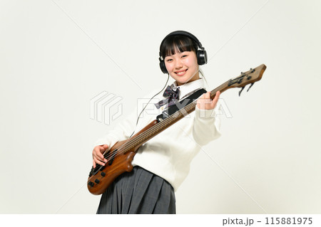 ヘッドフォンをしてベースを弾く女子高生　  115881975