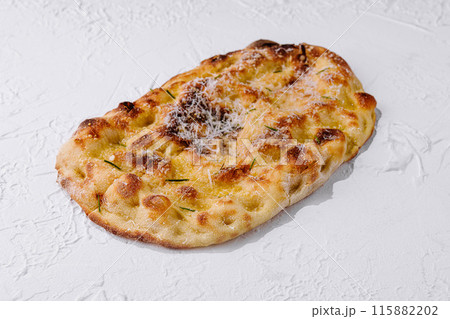 Freshly baked cheesy flatbread on white background 115882202