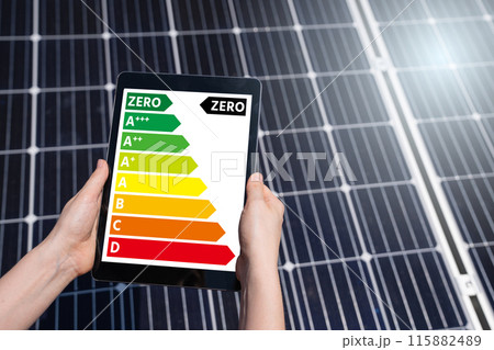Hands with digital tablet on a background of solar panels 115882489