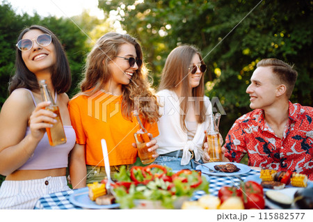 Happy friends in picnic in park. Friends grill meat, have fun, relax. ?oncept of holidays, weekends. 115882577