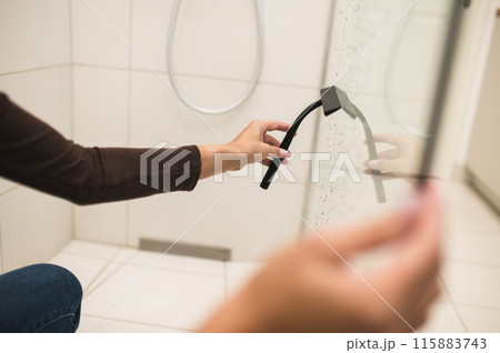 House wife cleaning the bathroom and a shower cabin 115883743