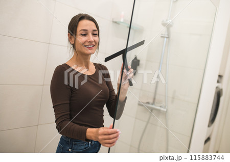 House wife cleaning the bathroom and a shower cabin House wife cleaning the bathroom and a shower cabin 115883744